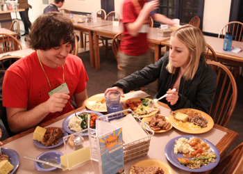 John Loranger, â€˜11, and Taylor Montminy, â€˜11, enjoy their plates of Soul food as part of the BSUs new dinner, which coincided with their annual dance. Credit: Klein