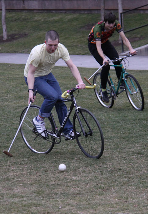 Brian Kearns, â€˜10, and Ethan Mansfield, â€˜11, race for the ball in a game of bike polo that was held on Saturday as part of the Cycling teams event week. Credit: Zipparo