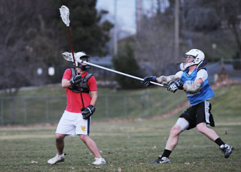 Stephen Over, â€˜11, and Ben Spencer, â€˜10, practice as part of the mens lacrosse team who with two games left in the season can clinch a spot in the leagues semifinal round with wins in both games. Last year the team made it to the semifinals before losing. Credit: Jacobson