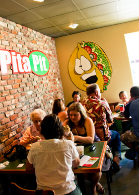Patrons enjoy the tasty yet healthy options from Pita Pit at its Colville Street location. It is the same building that Luscious by Nature used to occupy, which closed its doors last spring due to financial concerns. Credit: Cornelius