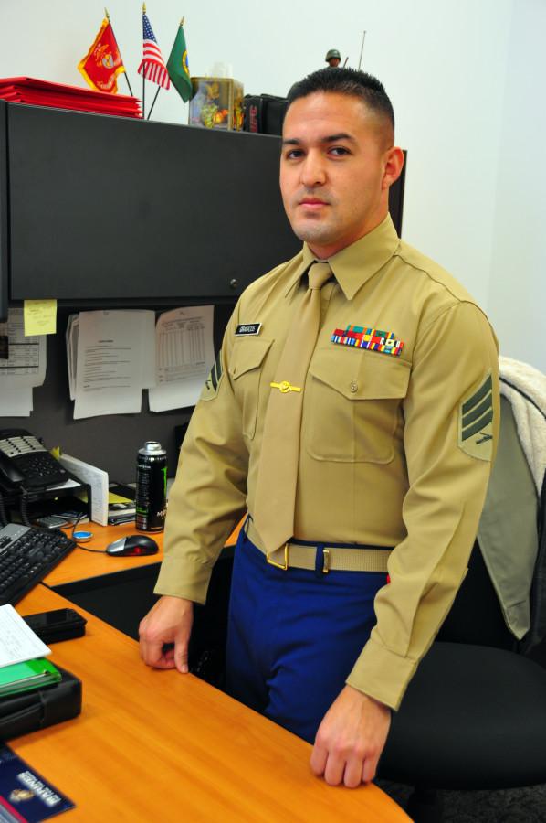 Sergeant Granados, a Marine Corps recruitment officer, stands behind his desk at the Armed Forces Career Center in College Place, WA.  Credit: Kendra Klag