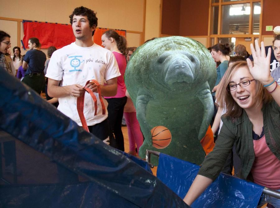 Morgan Walker and her Manatee face off in a round of carnival basketball in the Reid Ballroom during Manatee to Campus Day.  Photo Credit: Faith Bernstein; Illustration Credit: Ben Lerchin