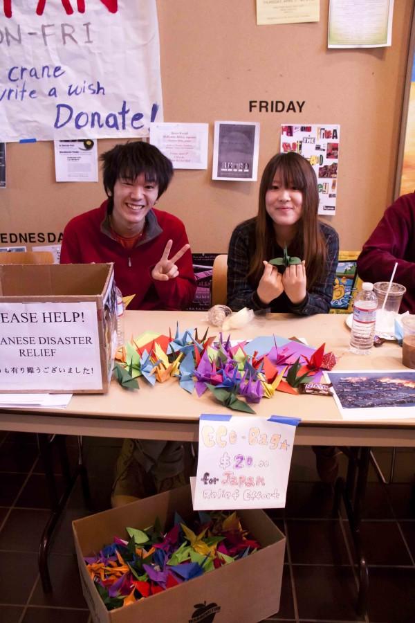 Two exchange students from Japan, Daichi Kusano (left) and Rino Miyazaki (right), fundraise for their home countrys ongoing recovery effort following the March 11th earthquake.  Photo Credit:  Kendra Klag