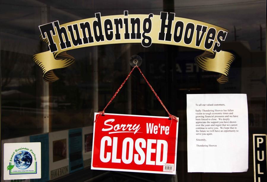The storefront window of Thundering Hooves announces its closure (at least for the foreseeable future).  Photo Credit: Brandon Fennell
