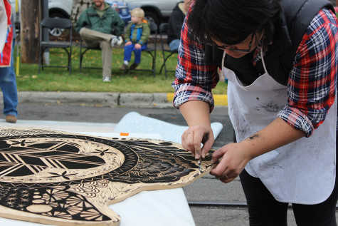 An artist makes some last minute touches to her block. Photo by Marra Clay. 