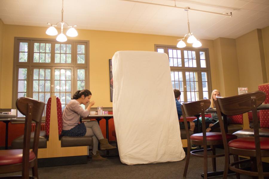 Sophomore Annie Want with a mattress in Prentiss Dining Hall. Photo by Marra Clay. 