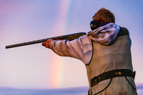 A Walla Walla resident trap shoots against a rainbow backdrop.  Photo by Tywen Kelly.