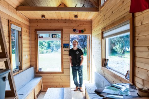 Sophomore Brayden Preskenis stands with the tiny home he has been building since he was 13.