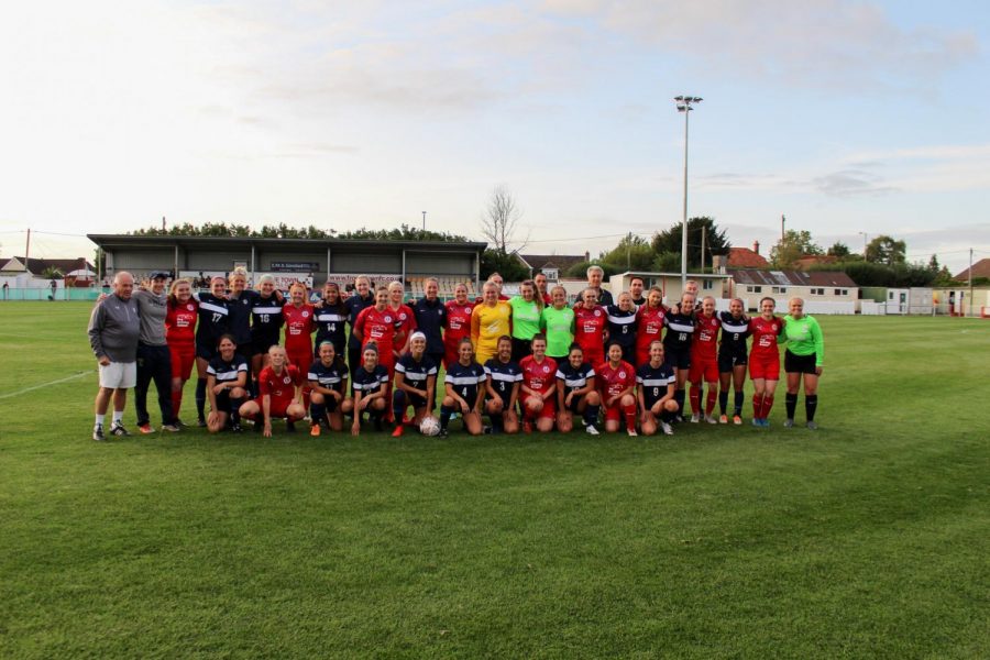 The women’s team poses with Frome Town FC, an English football club, after their match. Photo contributed by Whitman Athletics. 