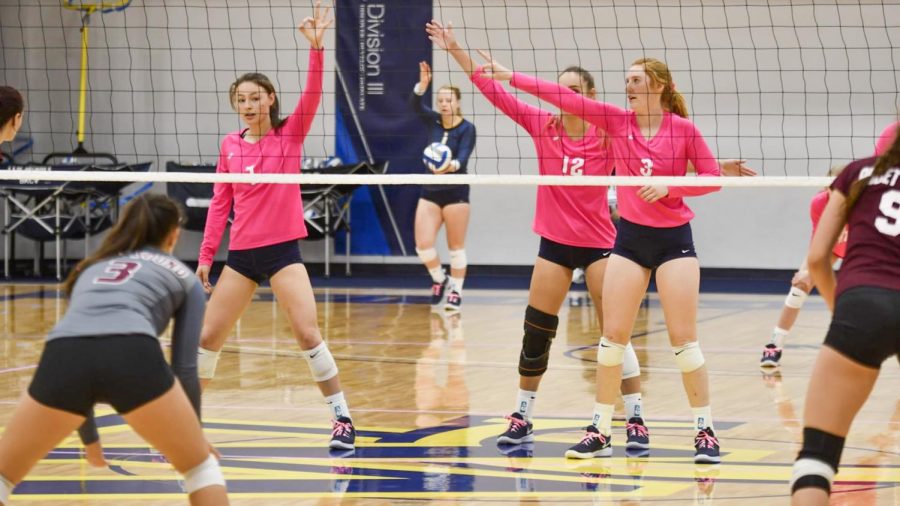 First-year Christina Boxberger (left), junior Elyse Benavides (middle) and junior Ruby Matthews (right) prepare for a serve versus conference opponent, University of Puget Sound. Contributed photo by Whitman Athletics