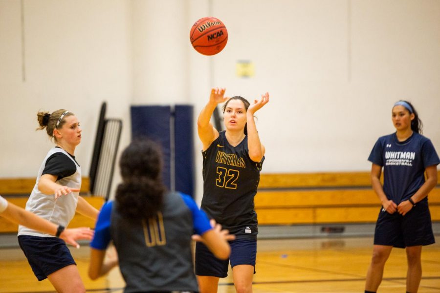 Senior forward Lily Gustafson passes the ball to first-year teammate Caira Young during the women’s basketball team’s first practice of the season