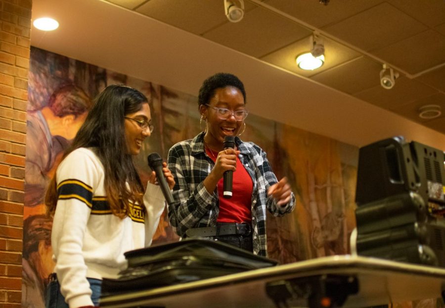 Sophomores Maya Mohan and Hannah Paul sing at the karaoke event